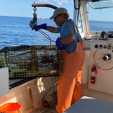 a person sitting in a boat on a body of water