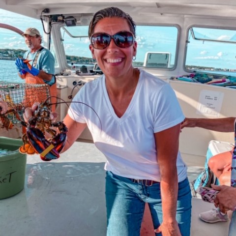 a person holding a hot dog