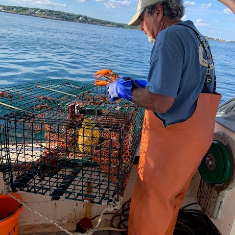 a man standing next to a body of water