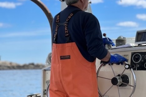 a man standing in front of a plane in the water